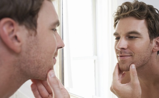 guy shaving in the mirror